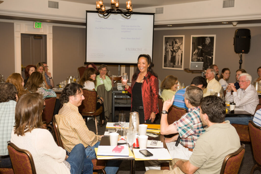 Photo of Ginni Galicinao speaking at a conference, red jacket, Events and Workshops