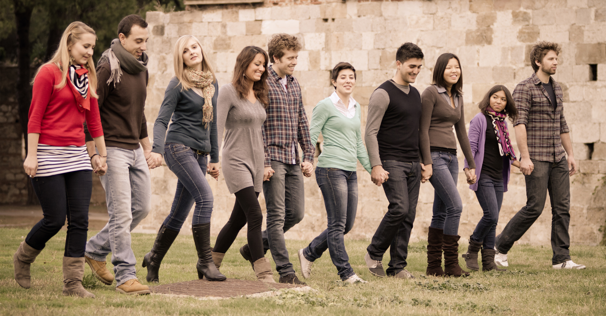 Young people walking in a line holding hands, next generation, rising generation, multi-cultural