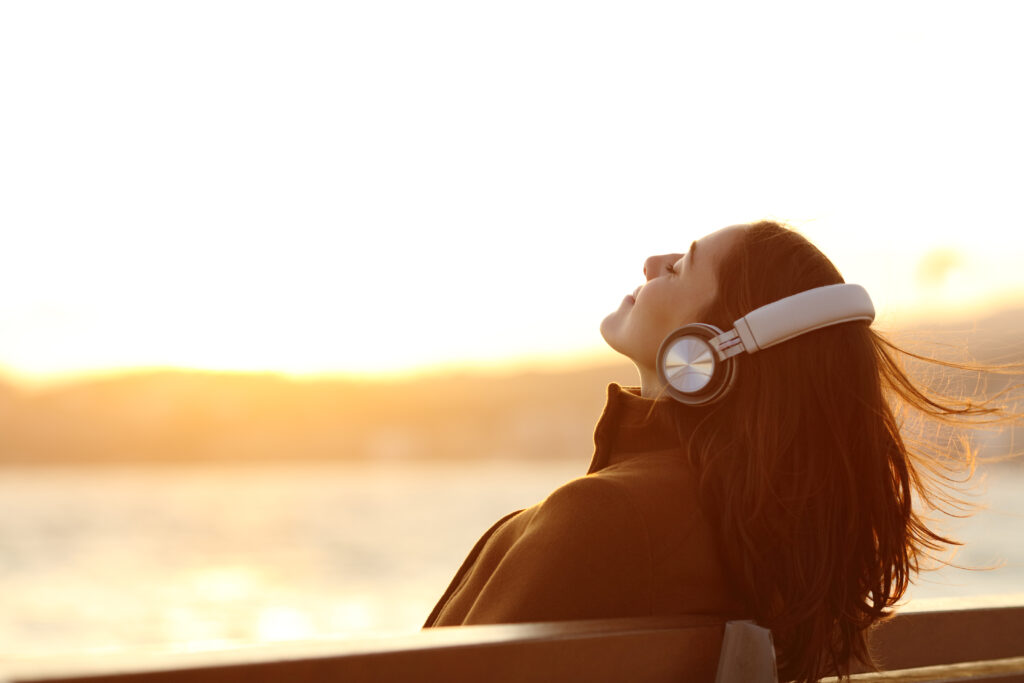 Podcast image, woman with head back listening with headphones