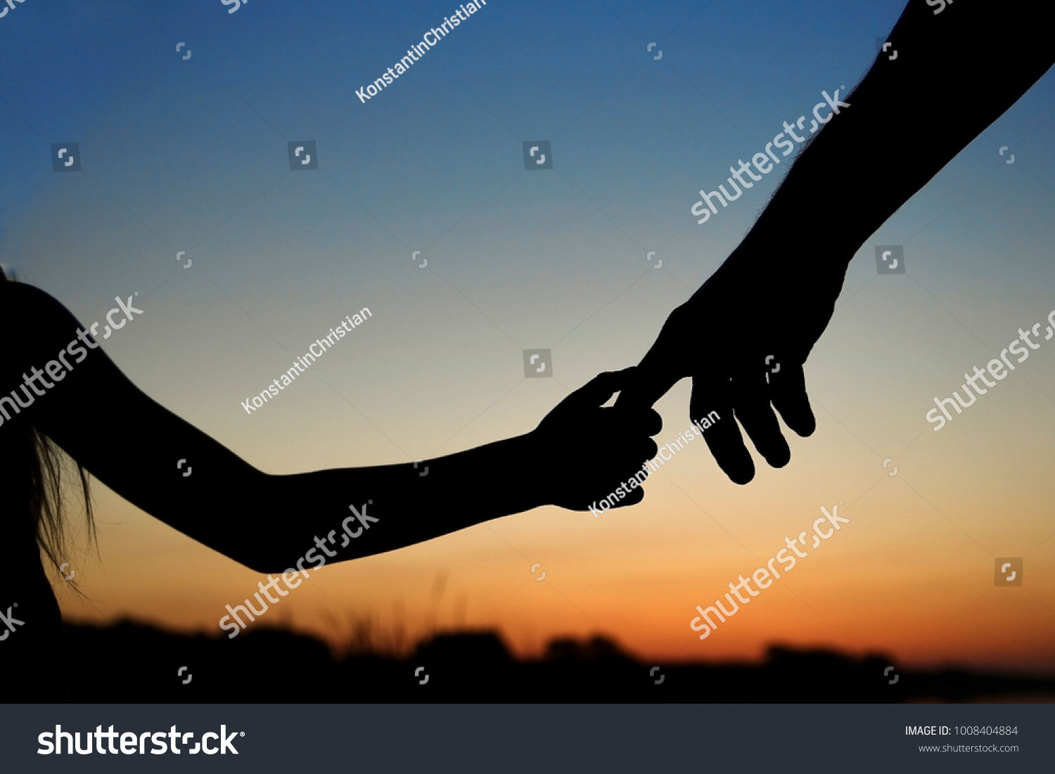 stock-photo-silhouette-the-parent-holds-the-hand-of-a-small-child-1008404884